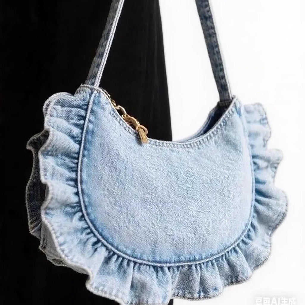 Denim blue cross-body bag with lace pleated trim and single shoulder strap, bucket shape.