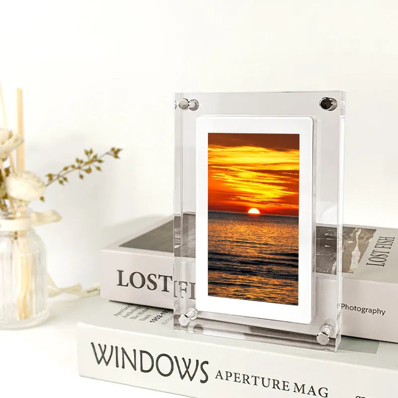 White vertical digital picture frame with 5-inch screen showing family photos
