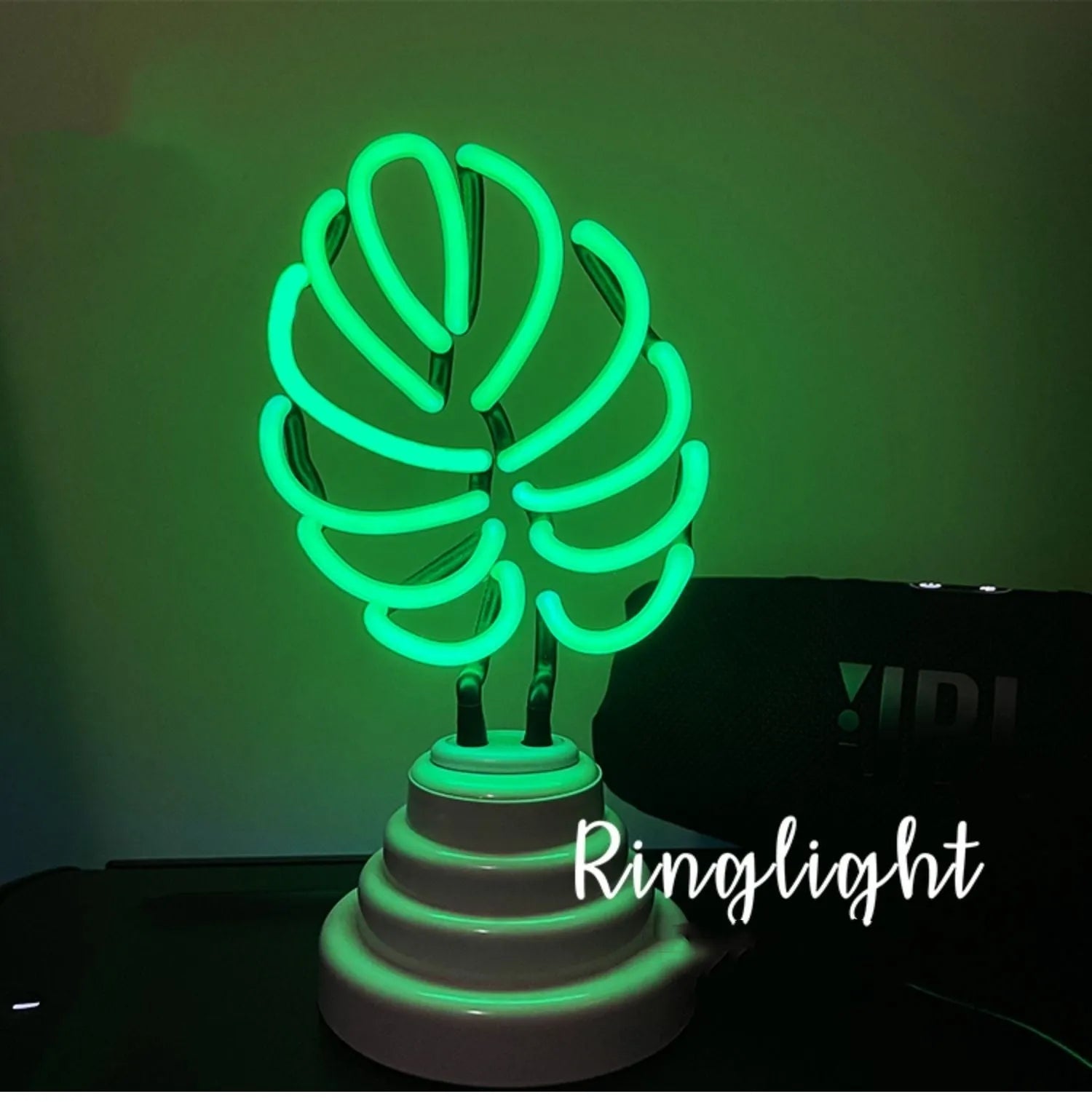 Minimalist white bamboo-shaped desktop lamp with a green glow, shown in two size options.
