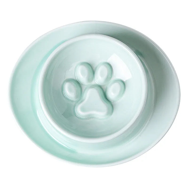 Green ceramic slow feeder pet bowl with raised centre and non-slip base.