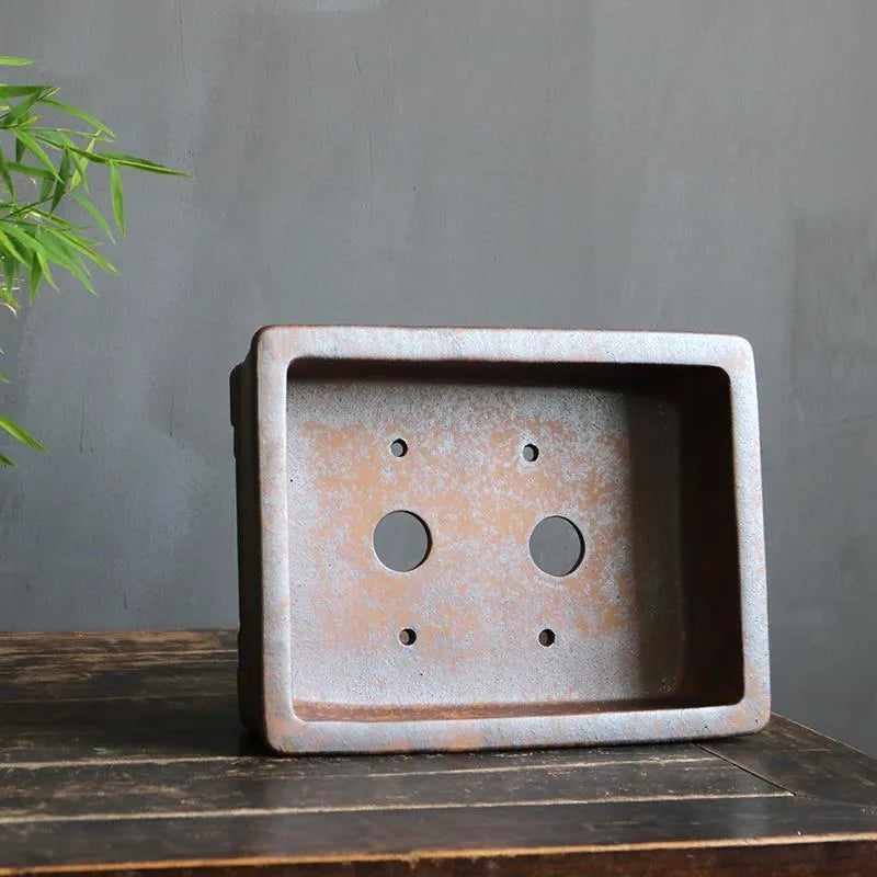 Rectangular purple sand bonsai pot with five-line textured pattern, shown empty on a wooden surface.