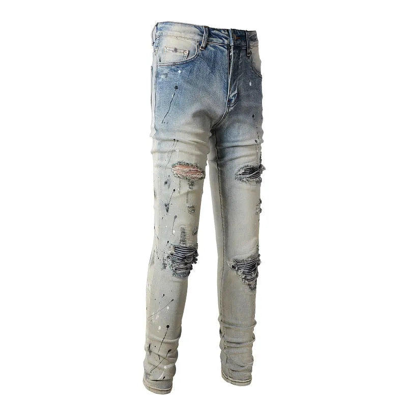 Men's blue light coloured paint splashing ink making old washed denim jeans with small straight leg and zip fly