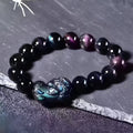 Natural ice colour obsidian crystal bracelet showing different bead size options on a wrist.