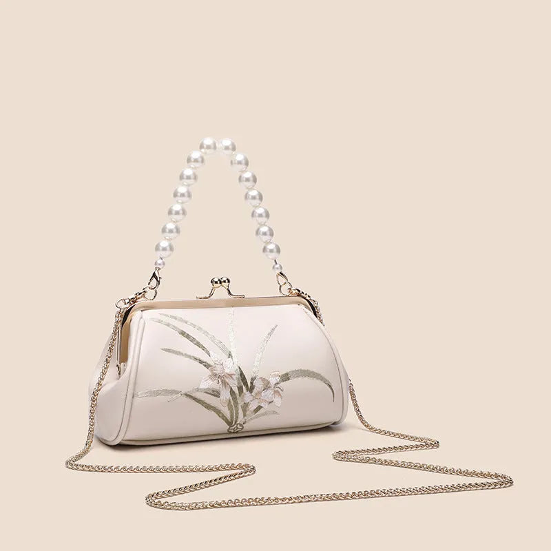 Beige women's shoulder bag with embroidery on soft PU leather in shell shape