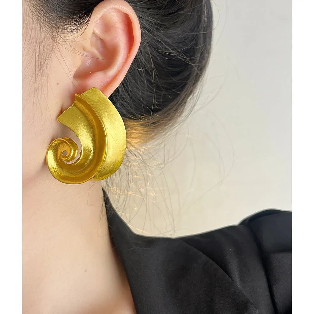 Retro geometric ear studs in gold or silver finish measuring 5cm with alloy construction