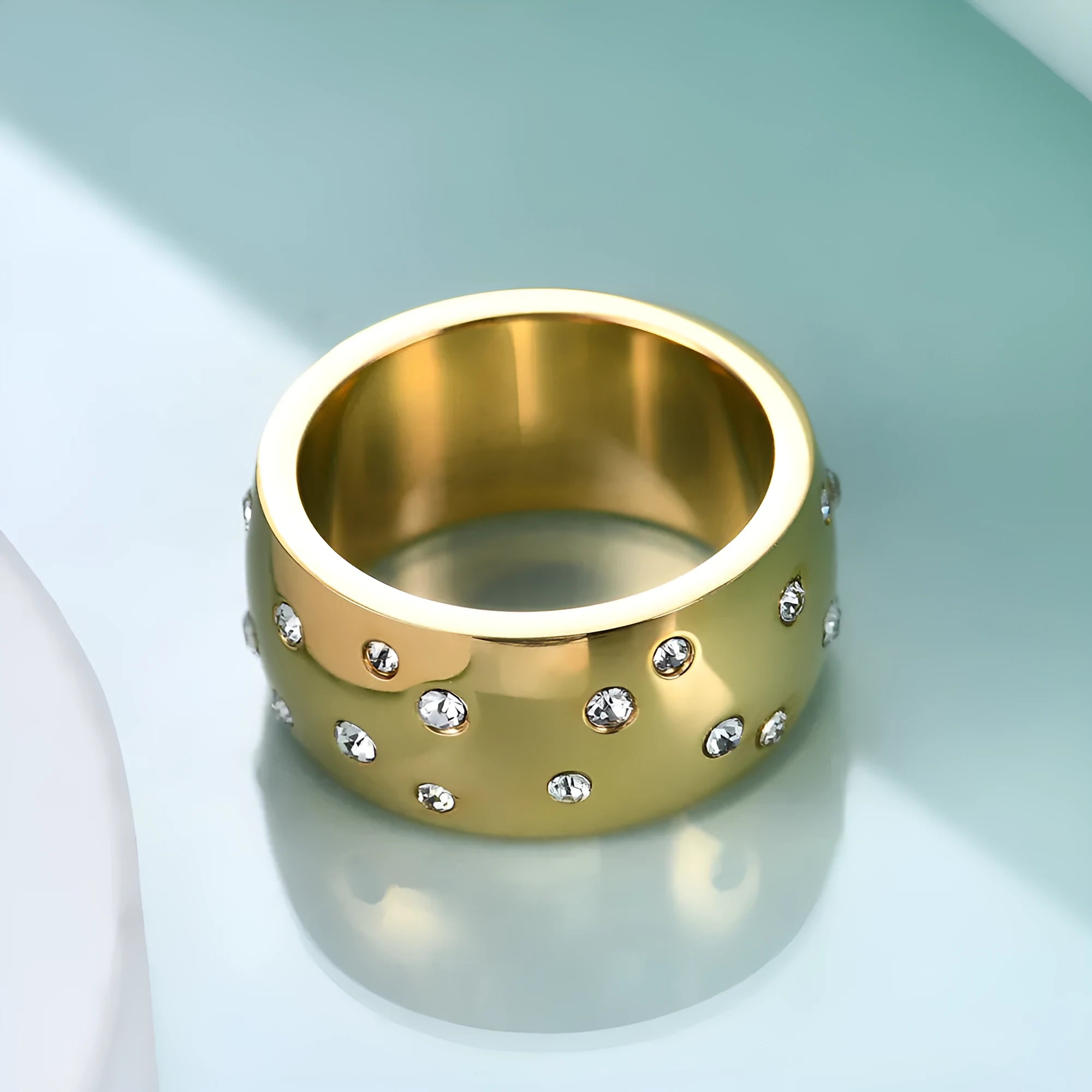 A women's titanium steel couple ring with diamond treatment and starry detail, shown in black, gold, rose gold and steel colour.