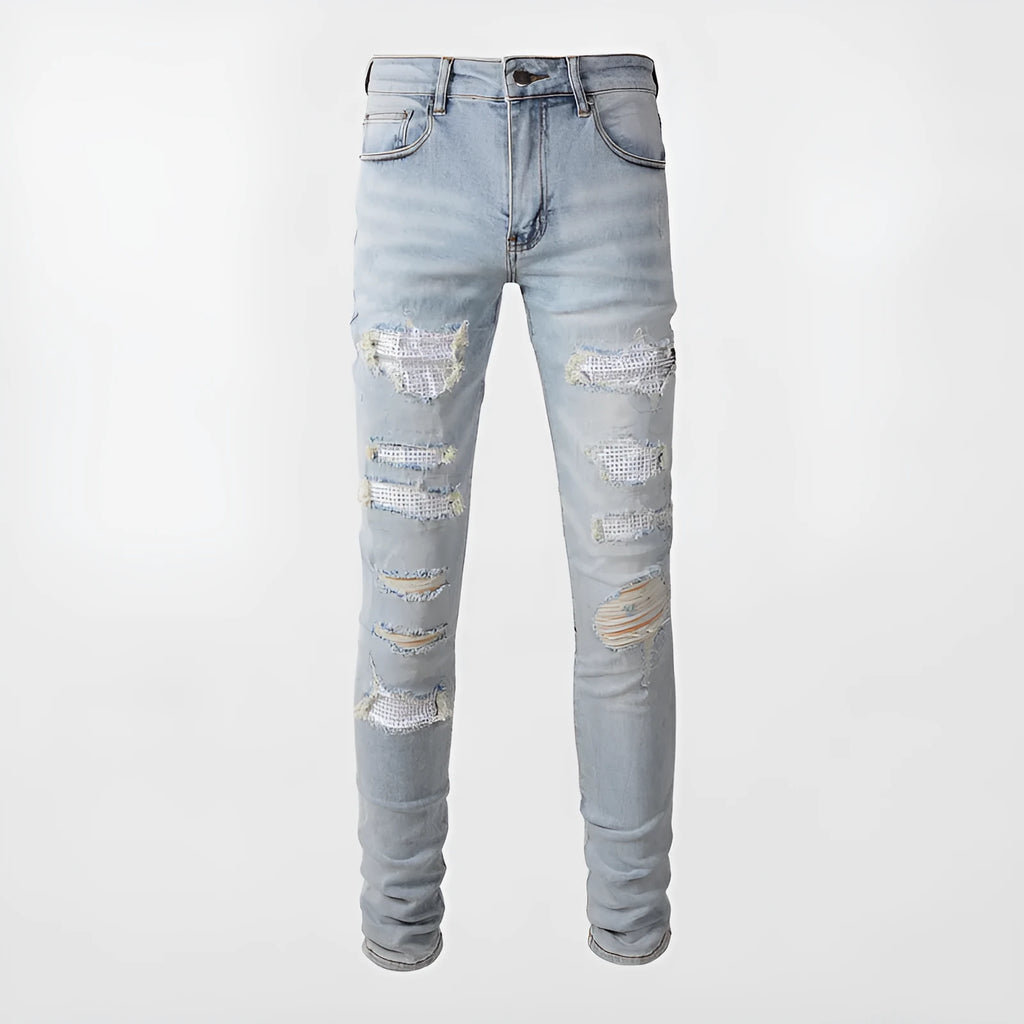 Light blue slim fit men's jeans with patch details, holes, and enzyme-washed finish