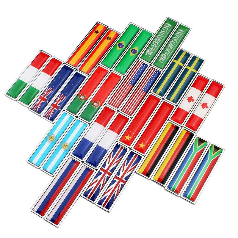 Pair of rectangular zinc alloy metal car badge stickers showing national flag designs, dimensions 58mm by 14mm.