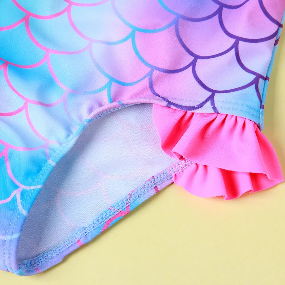 Girls' one-piece swimsuit with cartoon scale print and flounced gradient design in high elasticity nylon.