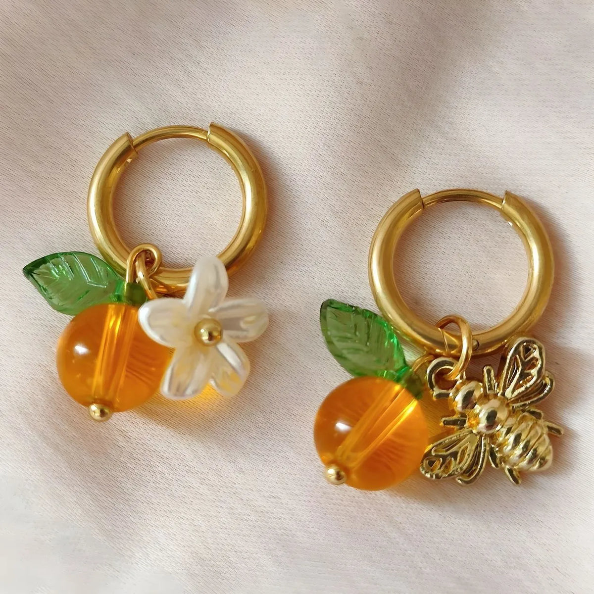 Yellow acrylic bee shaped earrings for women with honey fruit design and electroplated finish, Korean style pair