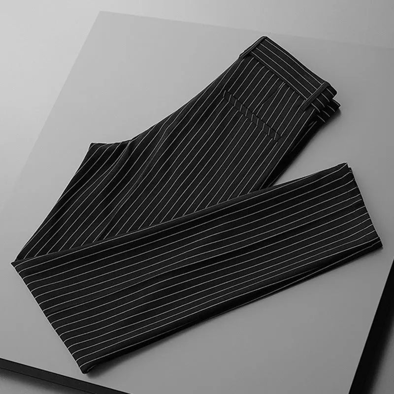 Men's thin striped loose suit pants with draping fit in black and white colours.