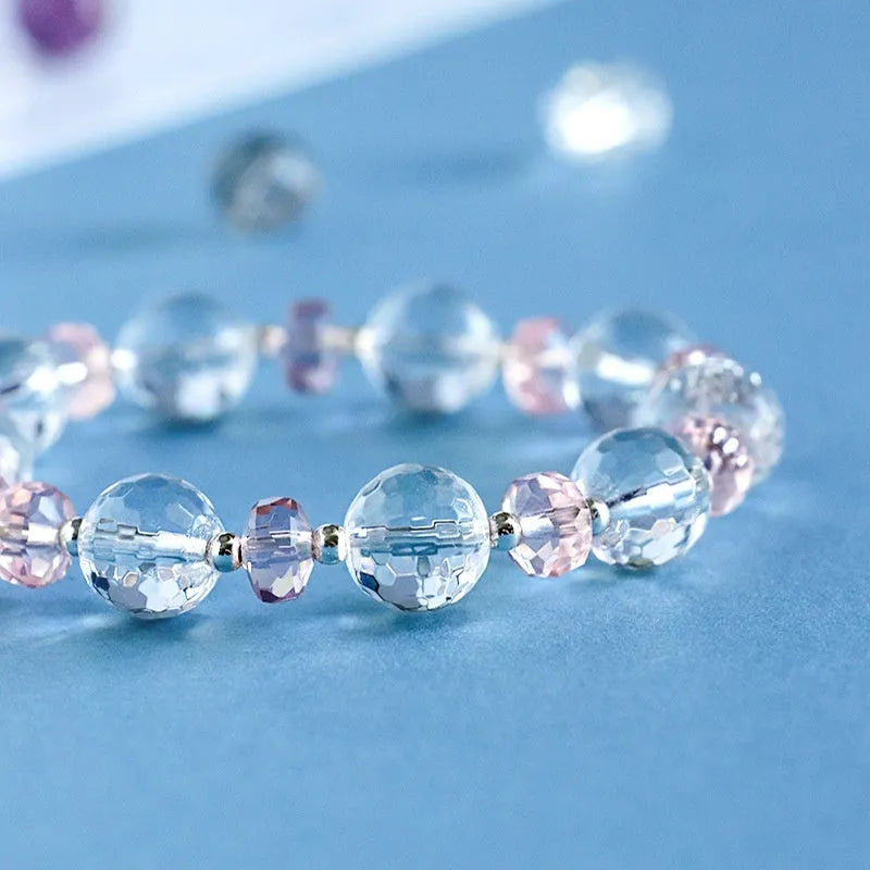 Women's white crystal bracelet with lucky cat charm and diamond-shaped stones on adjustable electroplated band