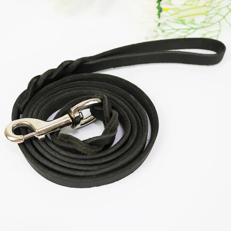 Thickened brown cowhide dog walking rope held in a hand, showing its length and simple strip design.