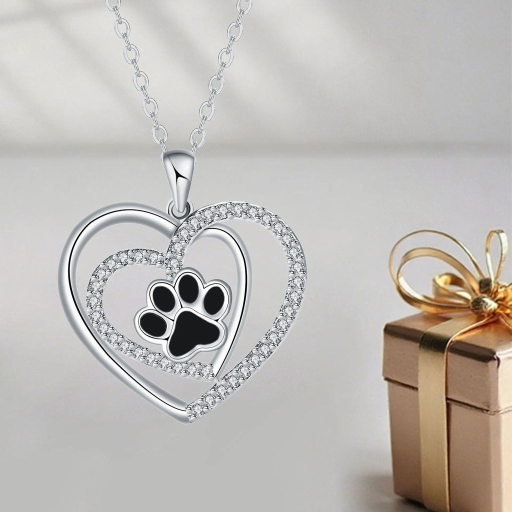 Women's copper dog paw print heart necklace on a cross chain.