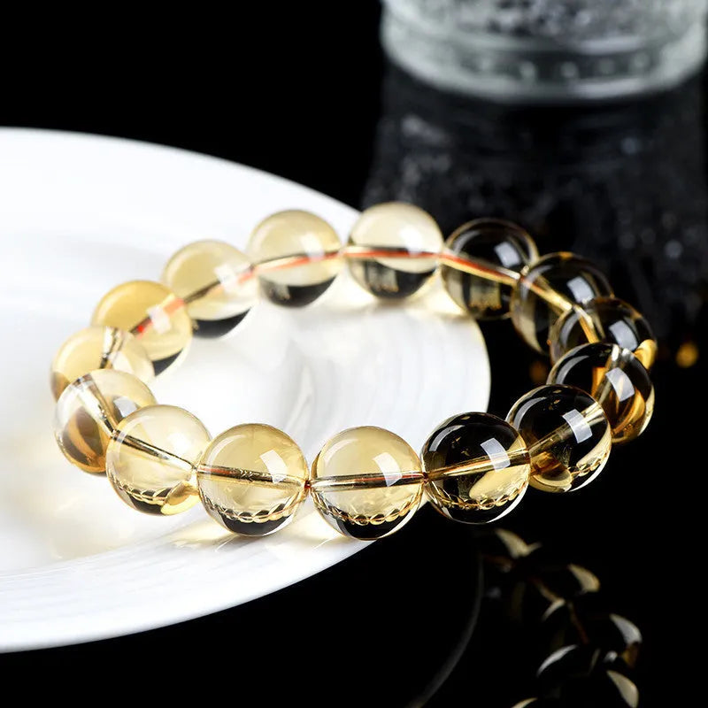 Original design natural citrine scattered bead bracelet on a wrist, showing polished stones in a golden hue.