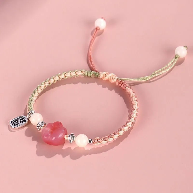 Handmade glass cat paw couple bracelet with red charm on pink or yellow woven cord