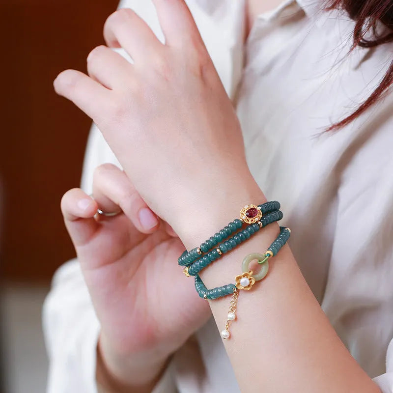 Women's blue water jade abacus beads bracelet with three tourmaline rings and pearl accents