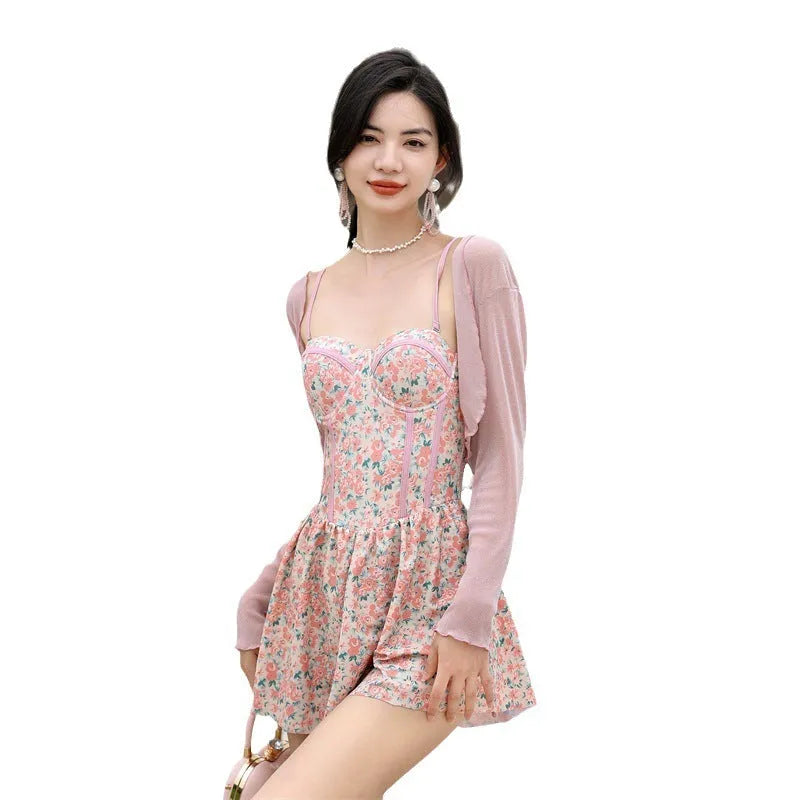 Pink floral one-piece women's swimsuit with suspenders, shown with matching smock.