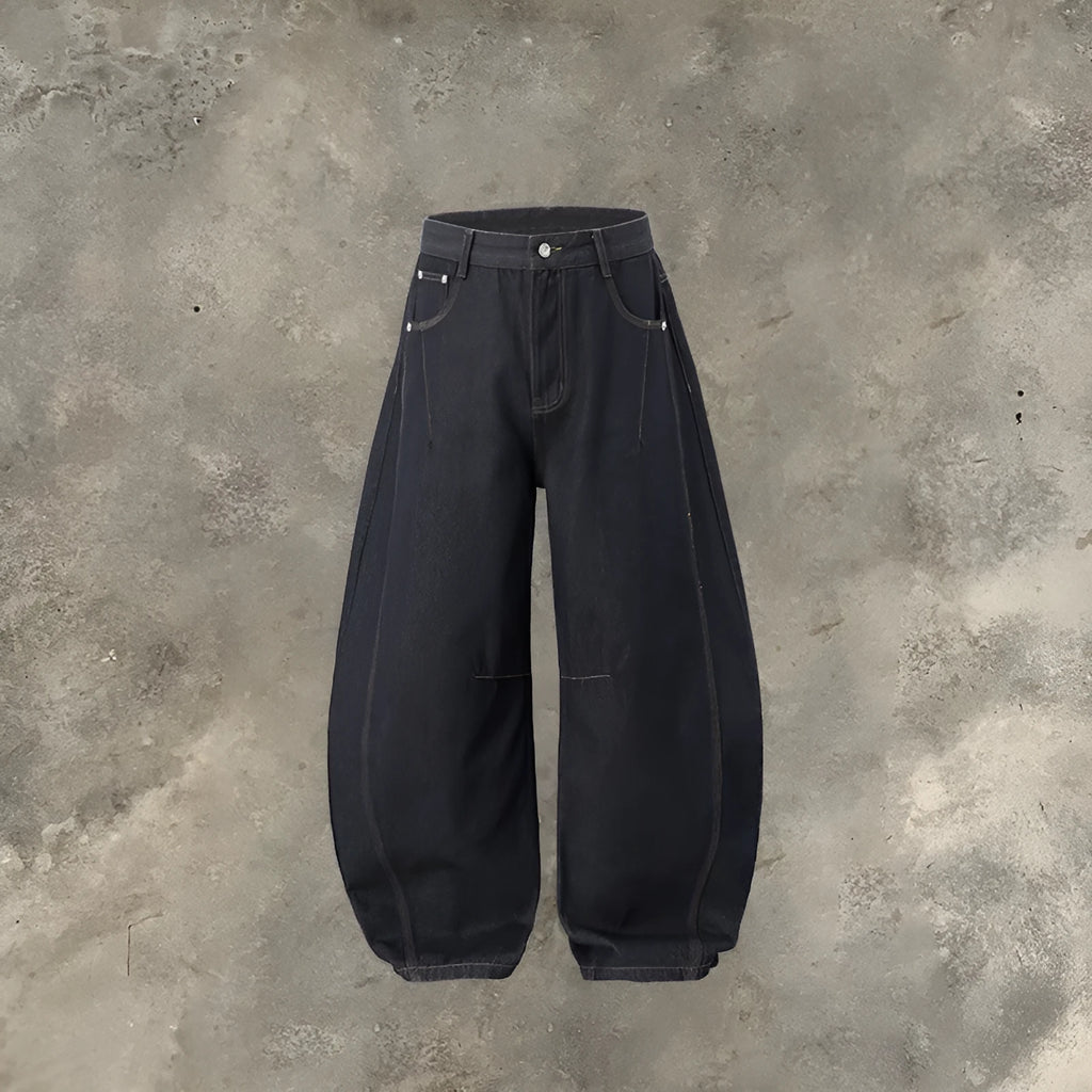 Men's wide leg denim trousers in original cow colour, laid flat to show mid-waist and relaxed fit.