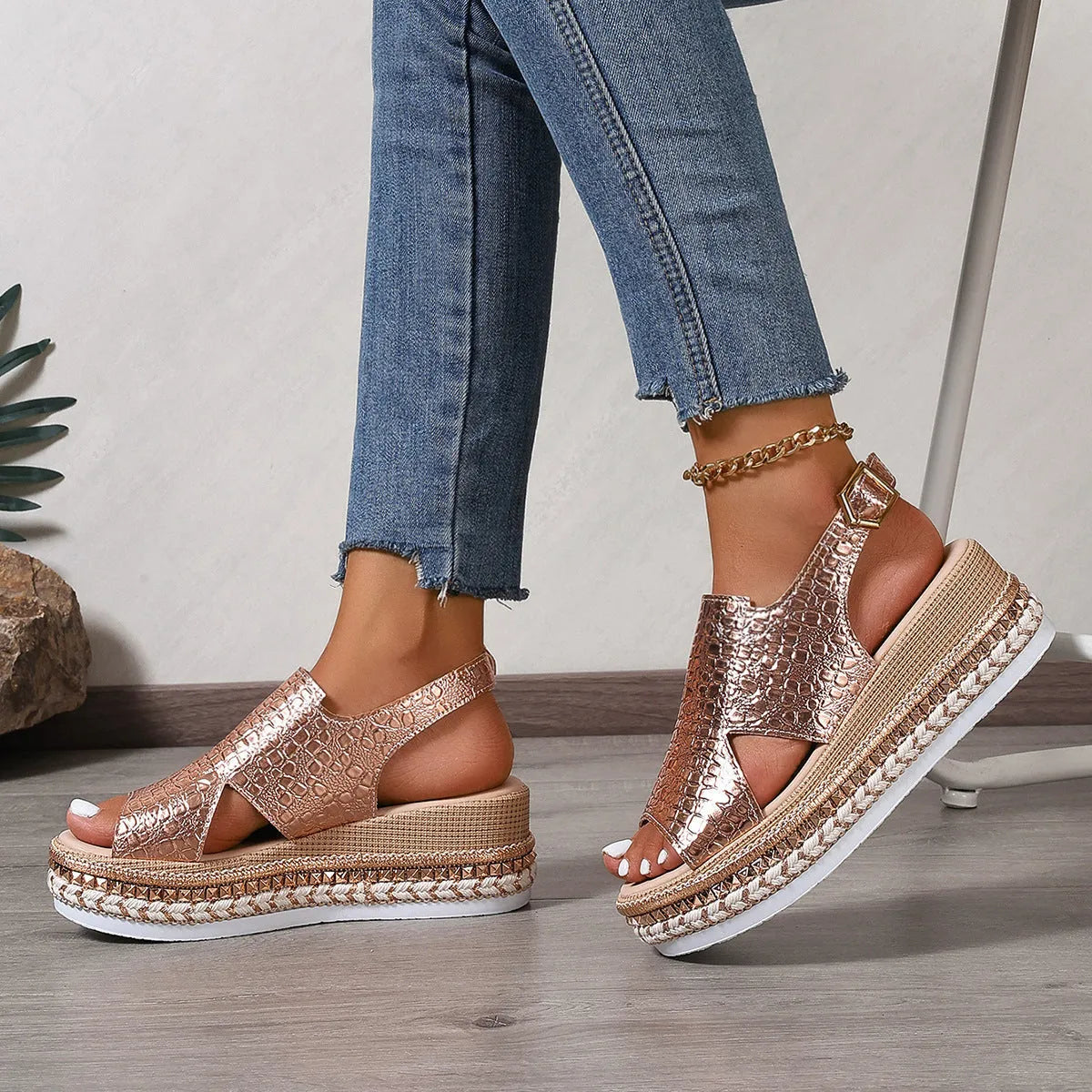 Gold women's Roman sandals with hollow-out design and an ankle buckle fastening.