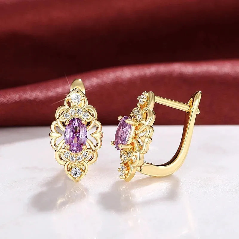 Gold copper flower earrings with hollow design and zircon stones on white background