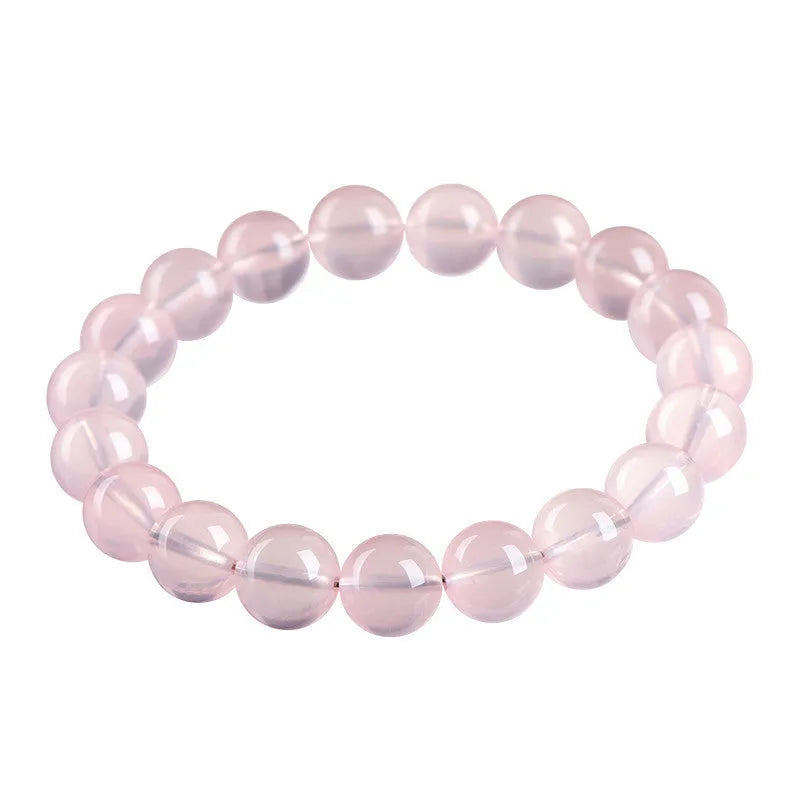 Natural crystal round bead bracelet with polished starlight effect in pink colour, showing bead detail and sizing options