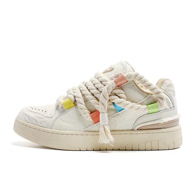 Creamy white Old Damage retro skate shoes with lace-up front and platform sole.