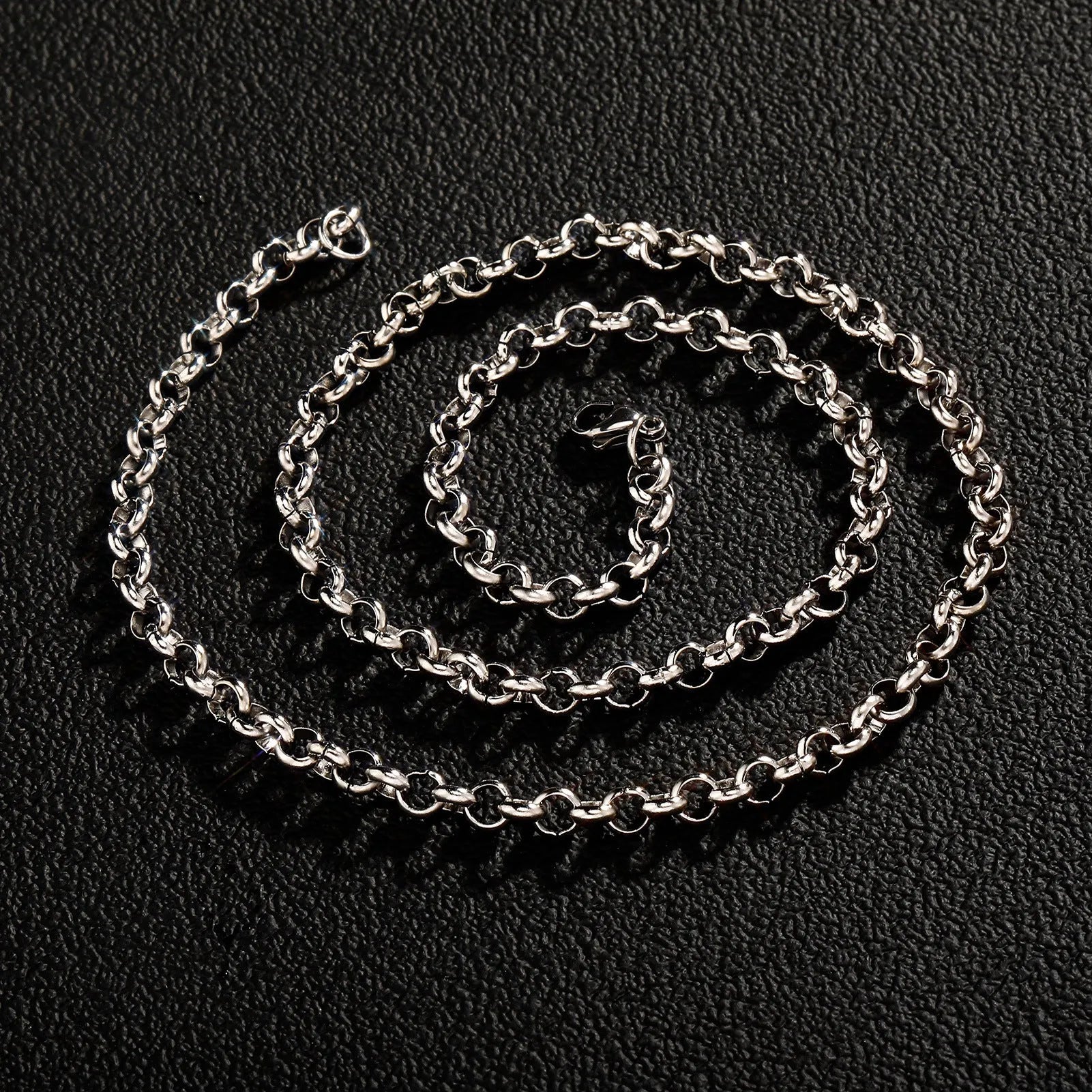 Silver stainless steel men's punk ring buckle necklace with O-ring chain and copper zircon pendant on display