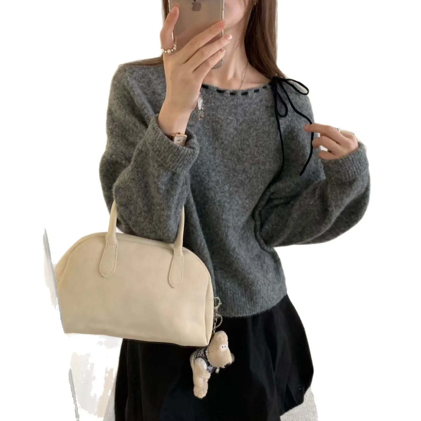 Grey loose-fitting women's long-sleeve knitwear pullover on a hanger.