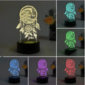 Black-based acrylic dream catcher night light with remote control on a table, showing colourful light mode.