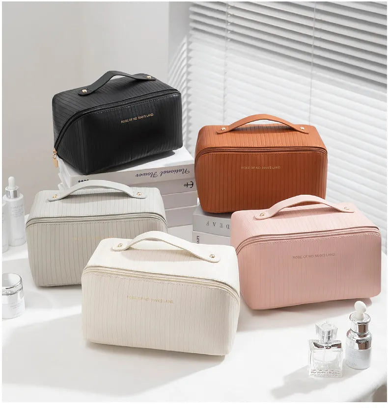 Vertical pattern pillow-shaped cubic makeup bag in PU material, shown in a neutral colour.