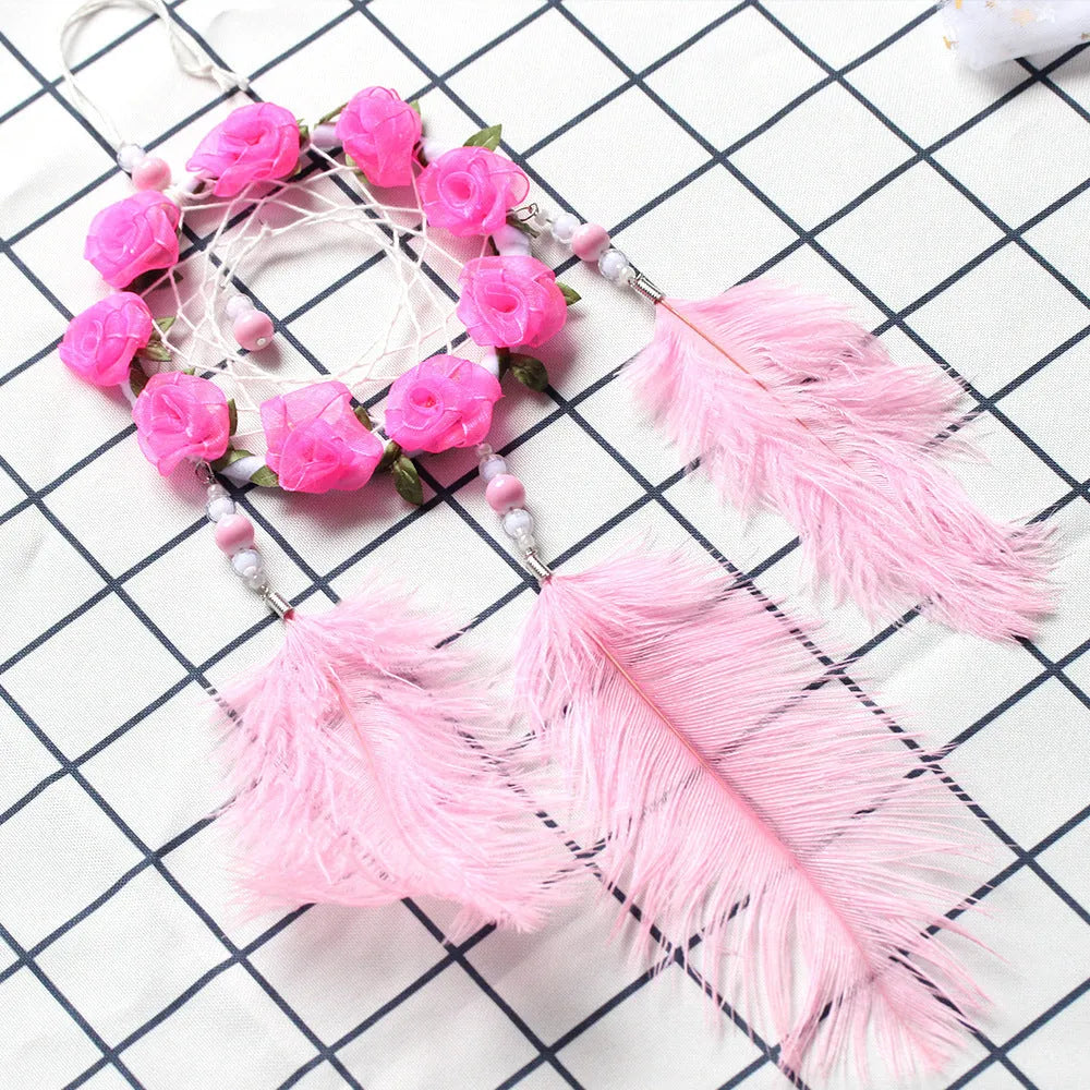 Pink ostrich feather dreamcatcher wall decoration ornament measuring 10cm.