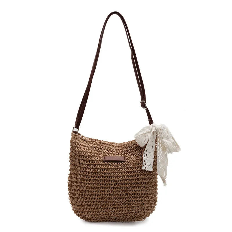 Women's woven straw messenger bag with hollowed design in khaki colour showing vertical square shape