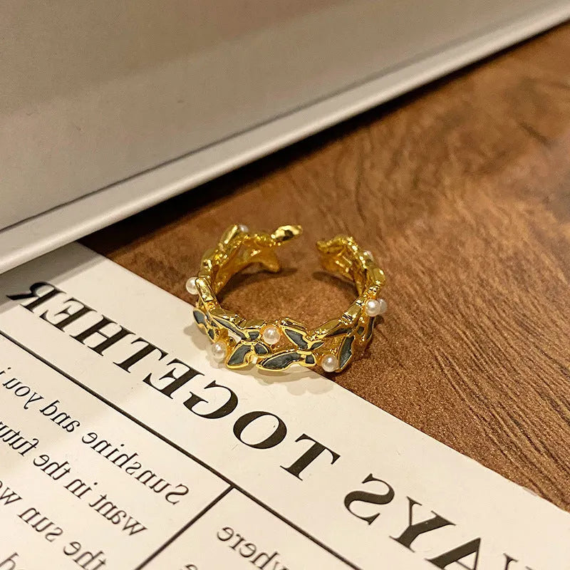 Copper butterfly women's ring with dripping oil texture and an open loop design.