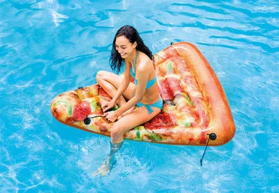 Large green pizza-shaped inflatable surfboard lounger floating on water