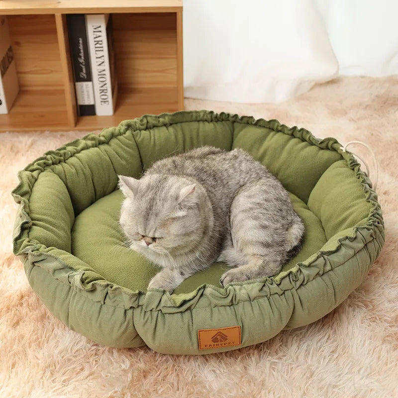 Grey reversible donut-shaped pet bed with a raised rim for a cat or small dog.