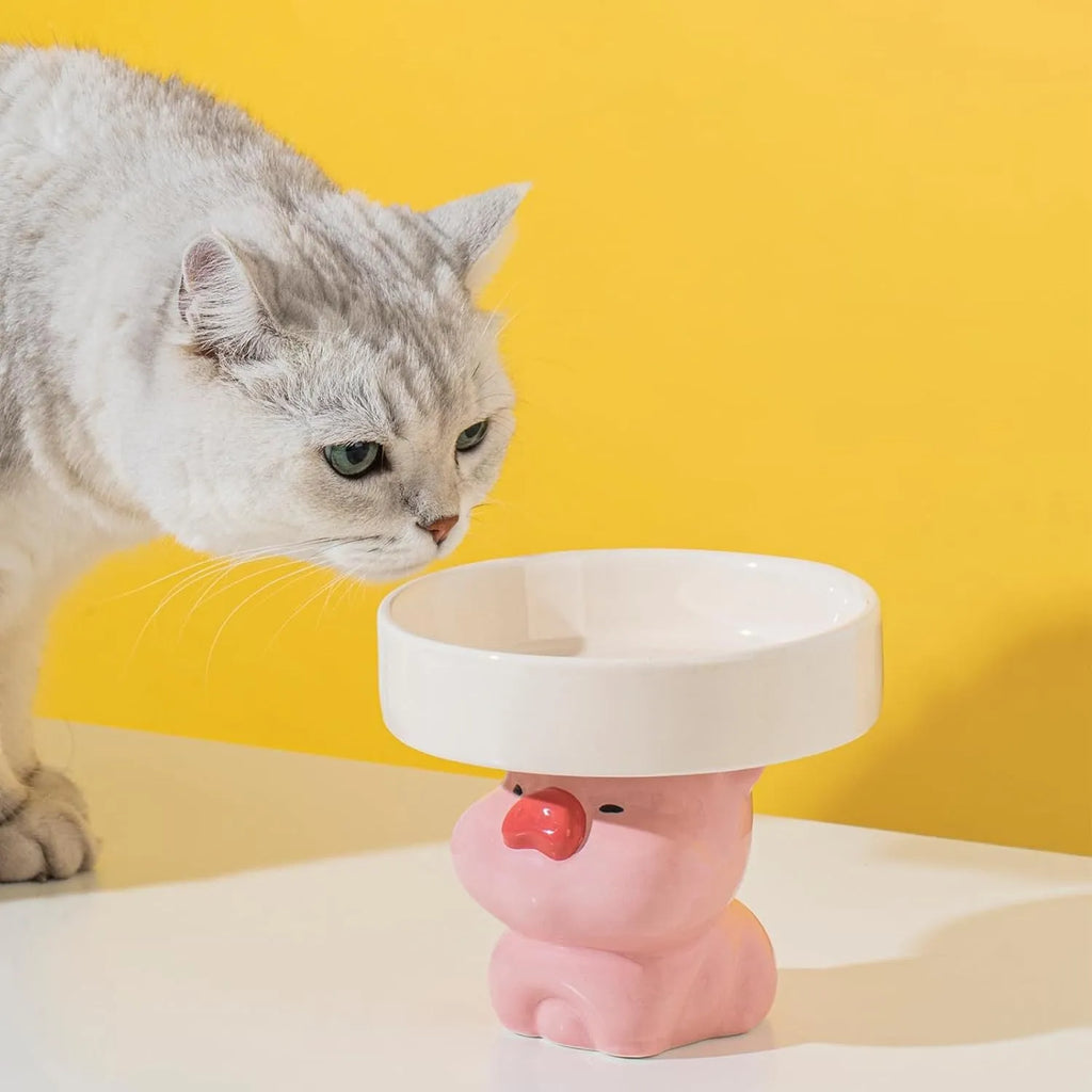 Raised ceramic cat bowl in animal theme design showing height and wide feeding surface