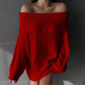 Woman wearing a loose red acrylic pullover sweater with long sleeves.