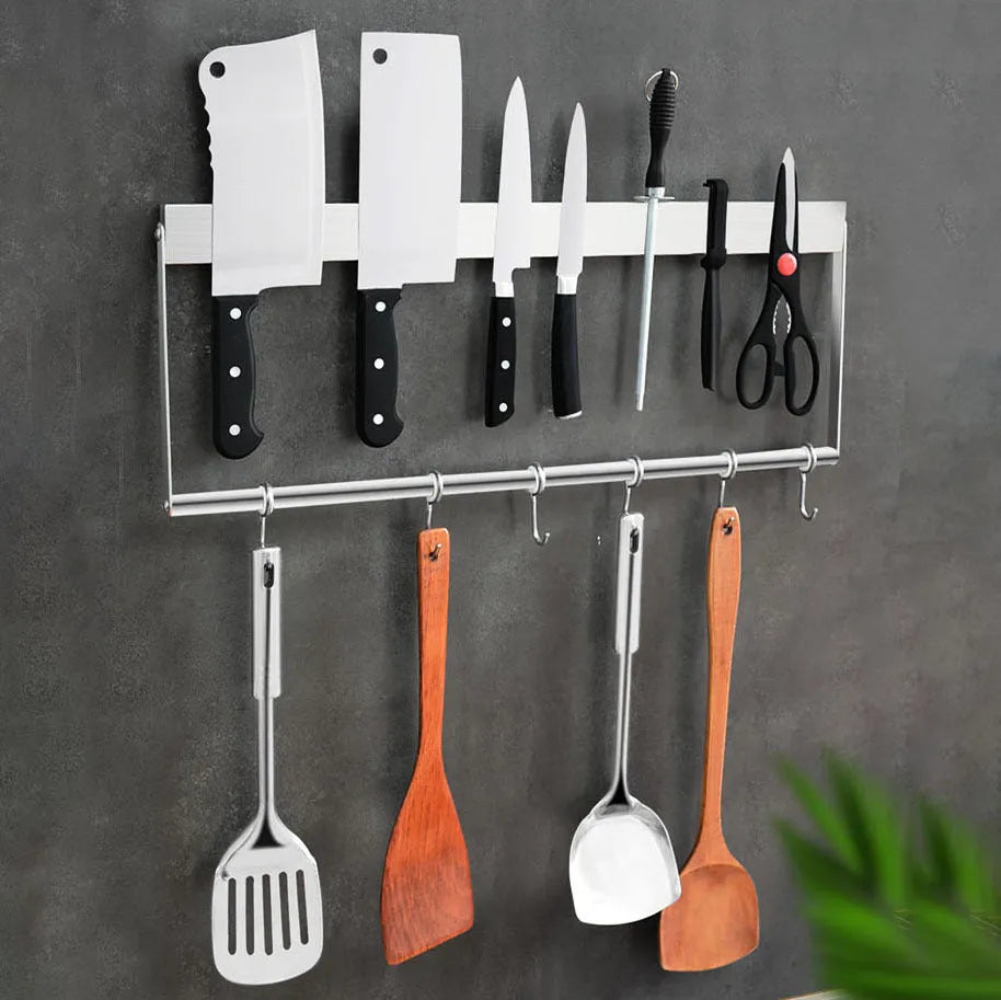 Stainless steel wall-mounted kitchen knife storage rack on a tiled wall