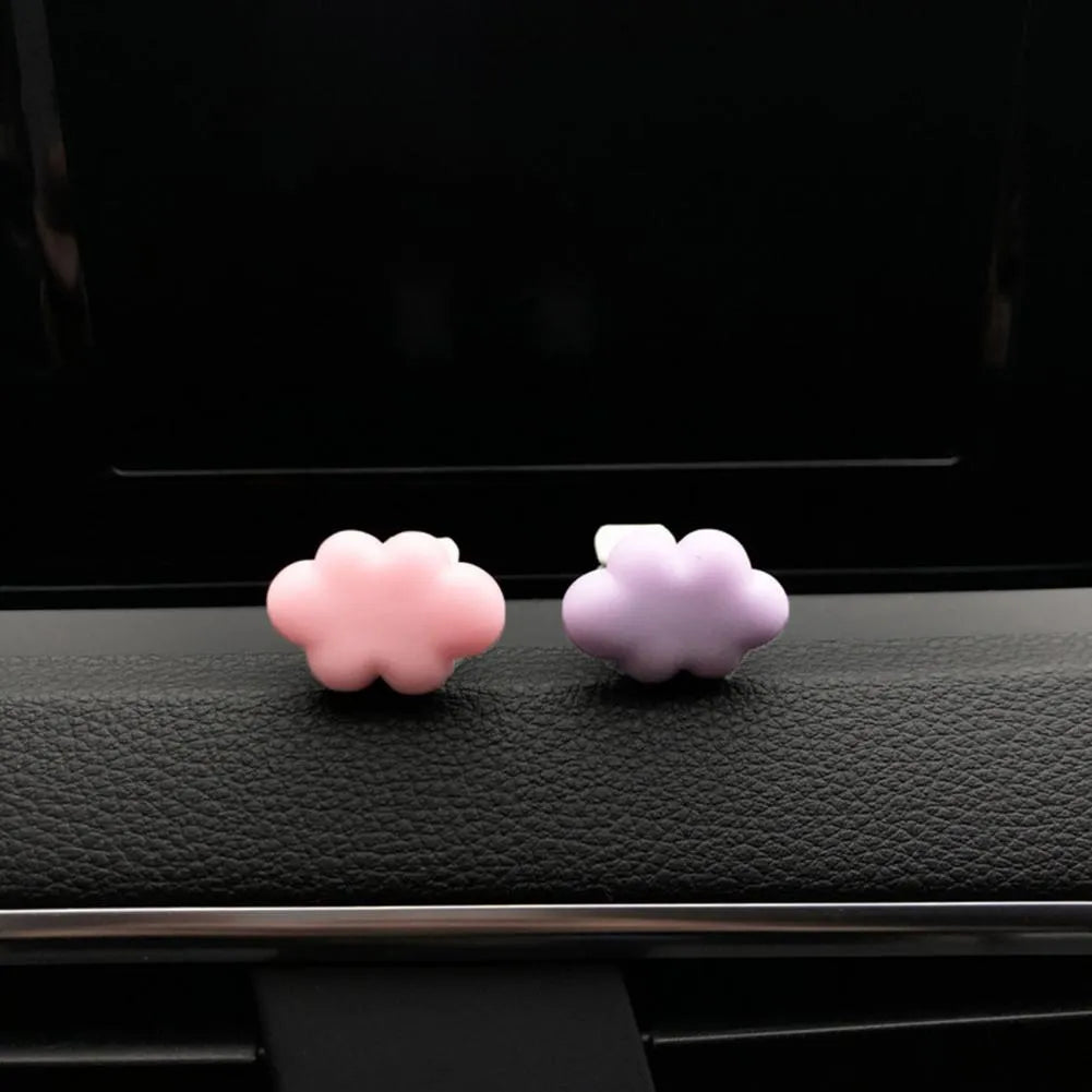 Colourful resin cartoon cloud car air freshener clip on a car vent.