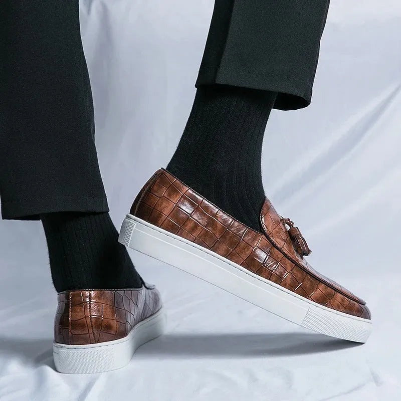 Plus size men's black tassel sneakers with round toe and oversleeve design on a rubber sole.