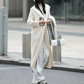 Long grey hooded cardigan sweater with a trench coat style, made from a wool and cashmere blend.