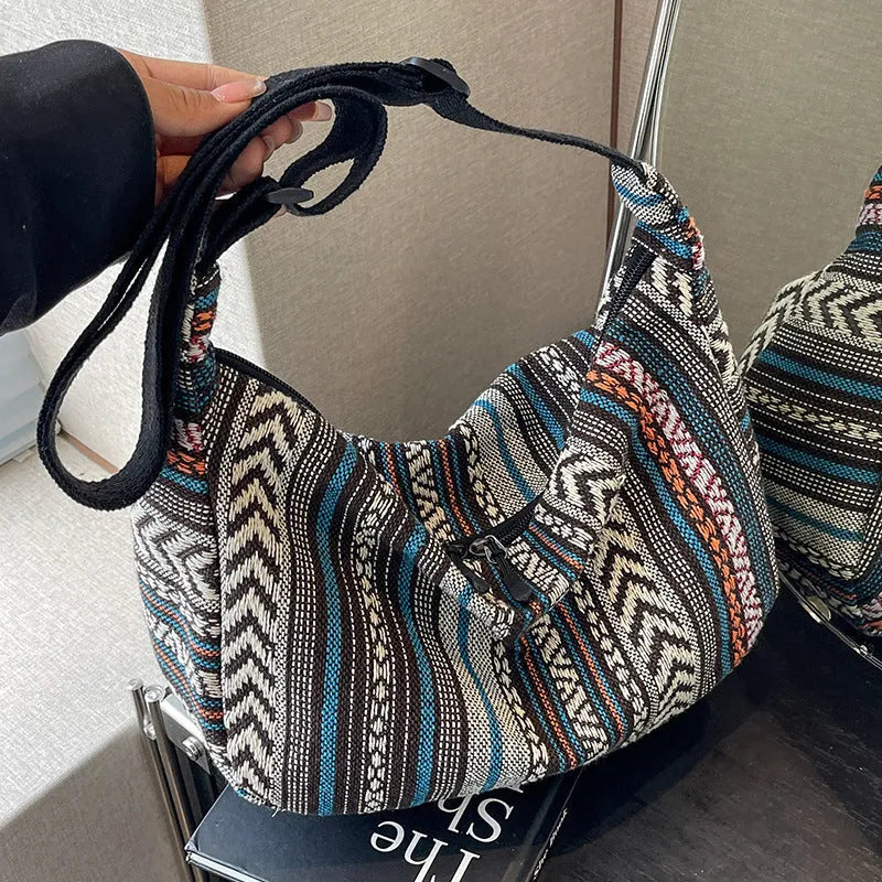 Women's ethnic style canvas dumpling crossbody bag showing sewing thread details and large capacity design
