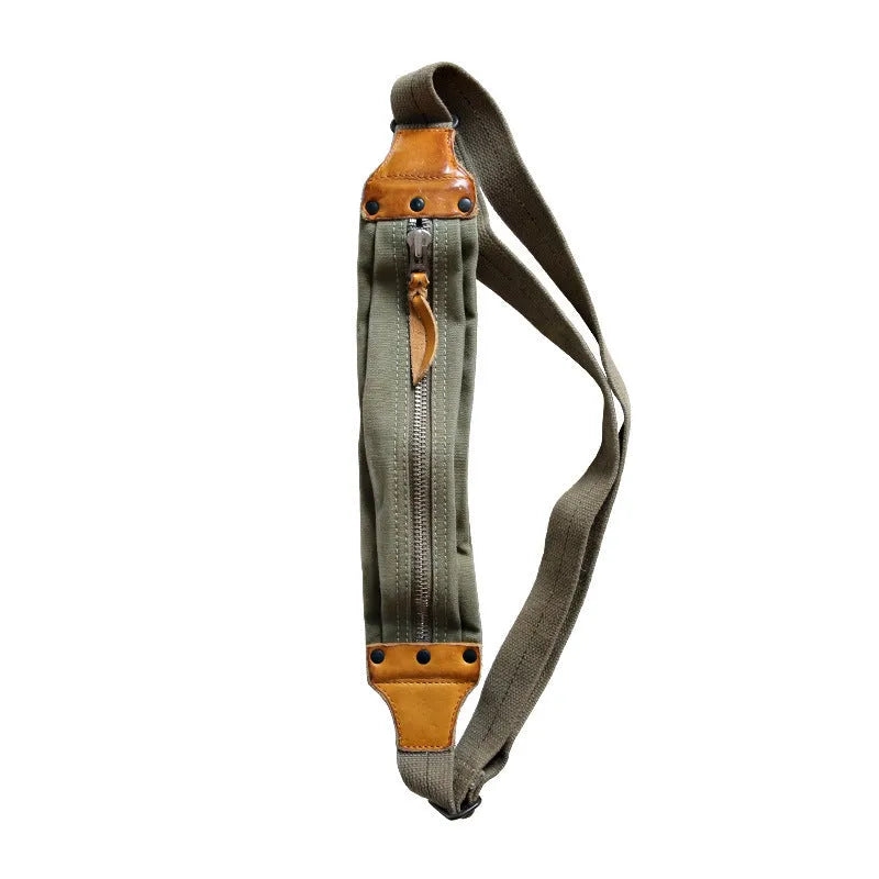 Green military style chest bag made from canvas with leather accents and anti-theft functionality