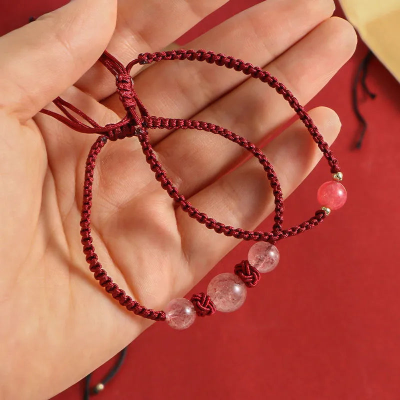 Woven red rope bracelet with strawberry quartz sphere beads and alloy detailing