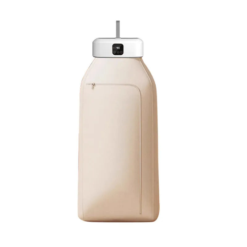 White foldable cylindrical laundry dryer with remote control on a table.