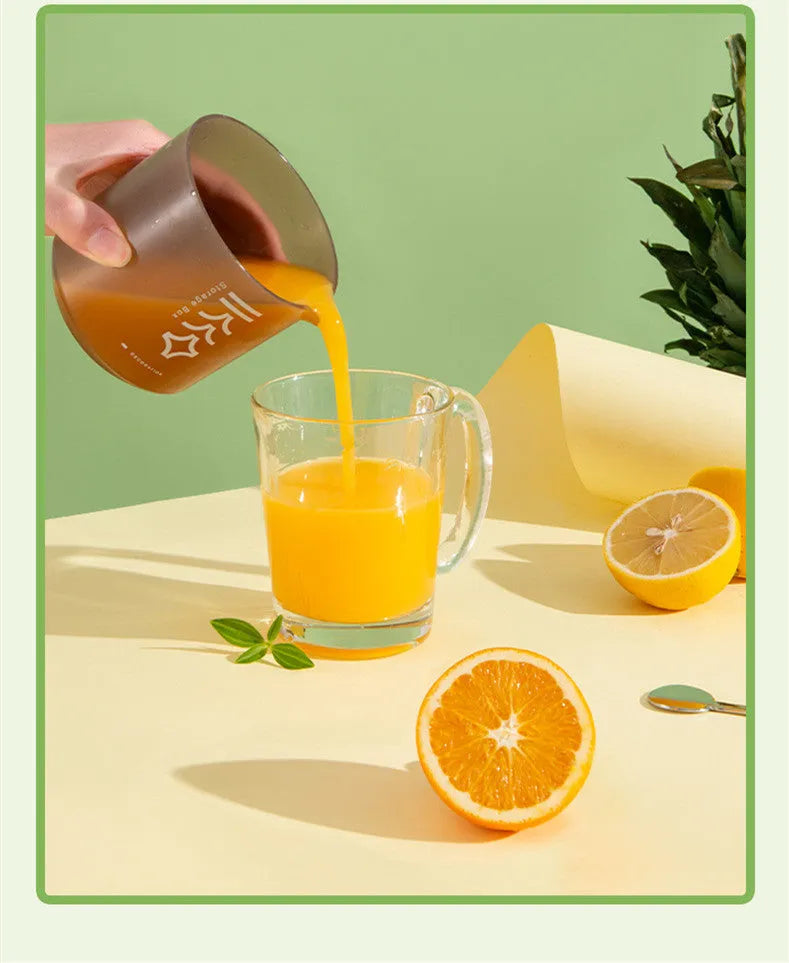Green manual citrus juicer with lid, showing its compact size and simple design for squeezing lemons and oranges.