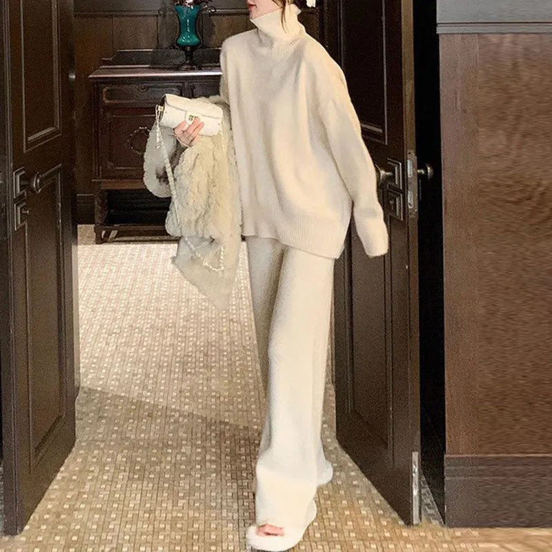 Women's beige acrylic sweater and wide-leg trousers two-piece set laid flat.