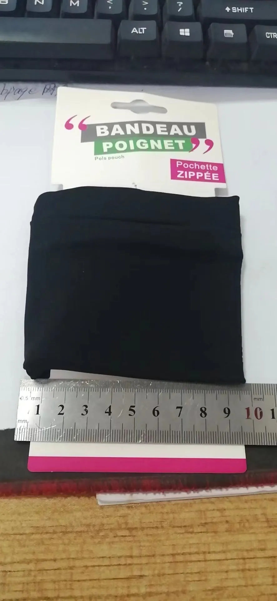 Black wrist armband with adjustable strap and a 10cm by 10.5cm main compartment for a mobile phone.
