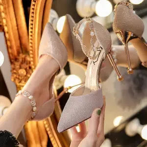 French high heel wedding shoes in silver with pointed toe, stiletto heel, and buckle closure on a clean background